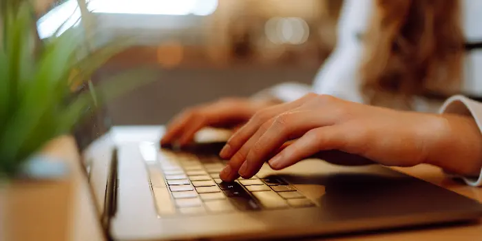 Women's hands on a keyboard performing image transcription